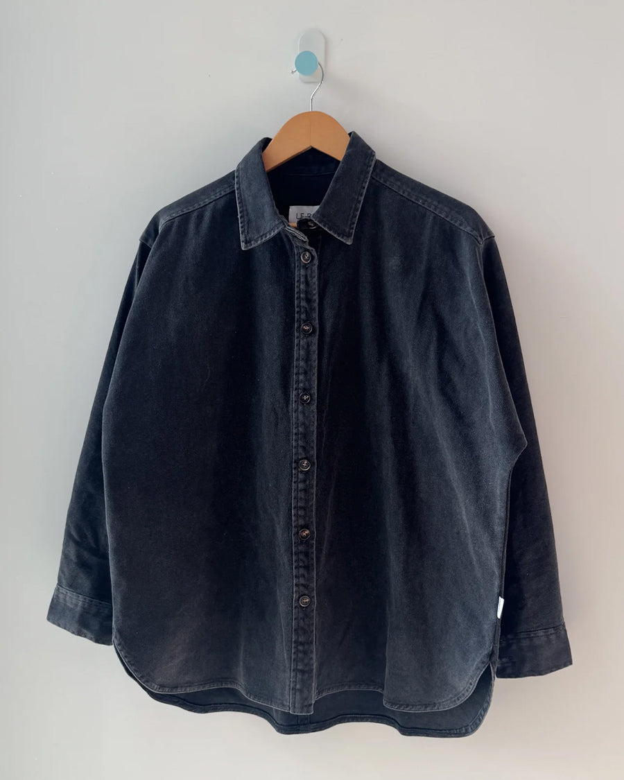 oversized washed black button down jacket on a hanger