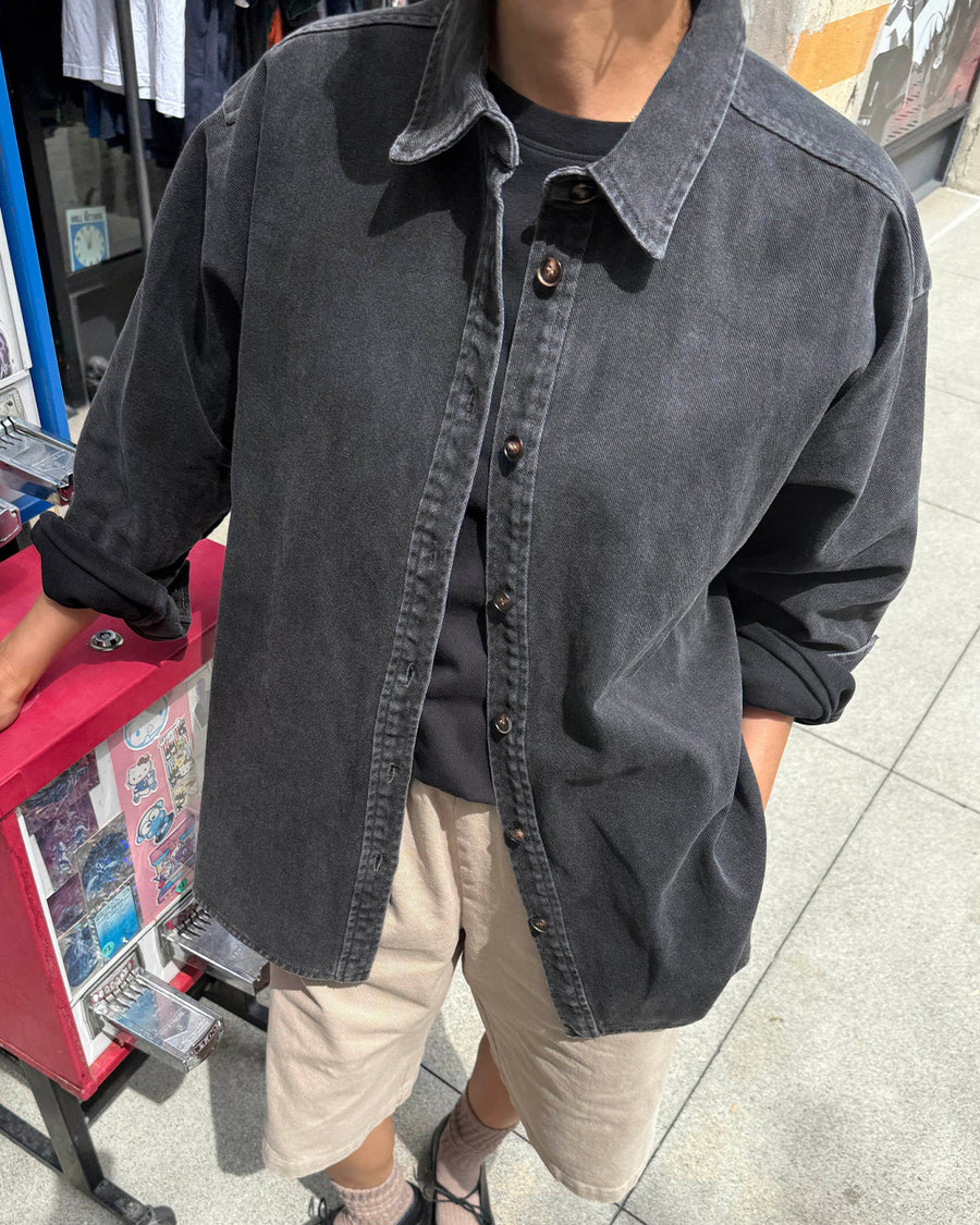 model wearing oversized washed black button down jacket