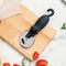 black cat pizza cutter on a cutting board