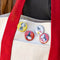 set of four snoopy halloween buttons: snoopy dracula, snoopy witch reading a book, snoopy skeleton, and snoopy witch head on a tote bag