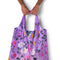 model holding purple reusable bag with pretty floral print