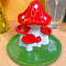 up close of red and white mushroom incense holder