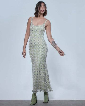 model wearing skin tight tank midi dress with green and white floral tile print