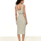 back view of model wearing vertical grey stripe midi dress with button detail on the waist