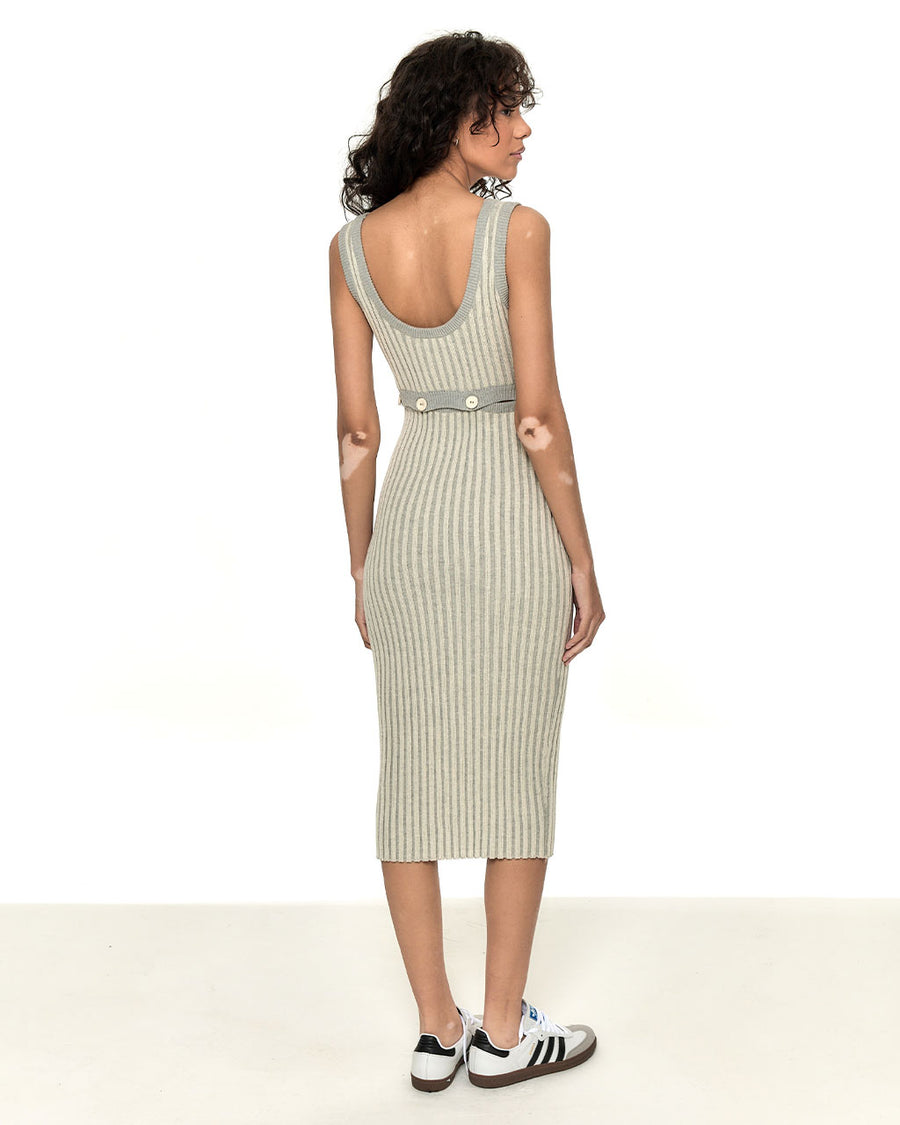 back view of model wearing vertical grey stripe midi dress with button detail on the waist