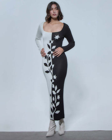 model wearing black and white split bodycon dress with vine and floral print down the center