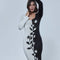 up close of model wearing black and white split bodycon dress with vine and floral print down the center