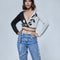 model wearing black and white split crop top with vine print and tie wraparound bottom