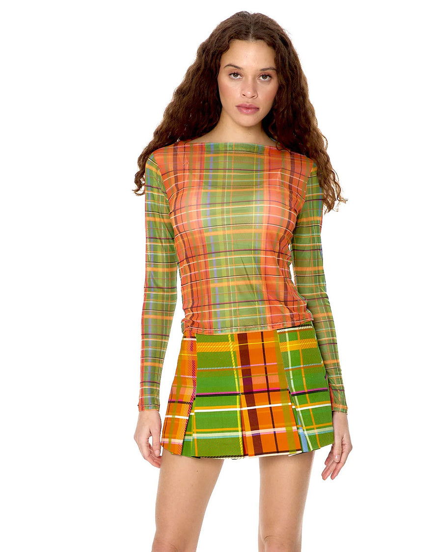 front view of model wearing orange, blue and green plaid sheer top with boat neckline and long sleeves