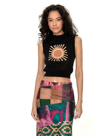 model wearing black sleeveless sweater tank with abstract sun print