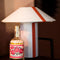 glass bottle with cream tipped matches and red flower stamp design on the bottle on a end table