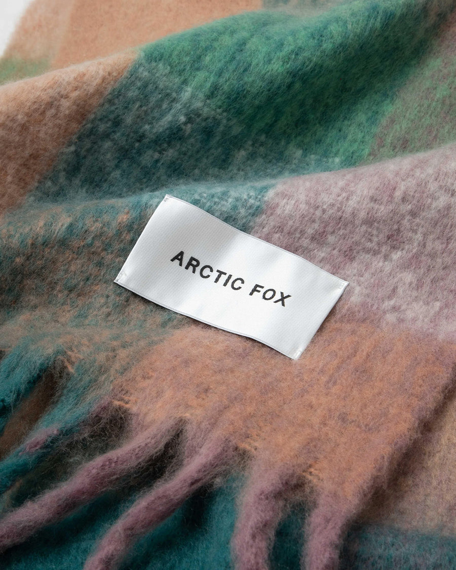 up close of teal, salmon, green and lilac oversized checker scarf with fringe