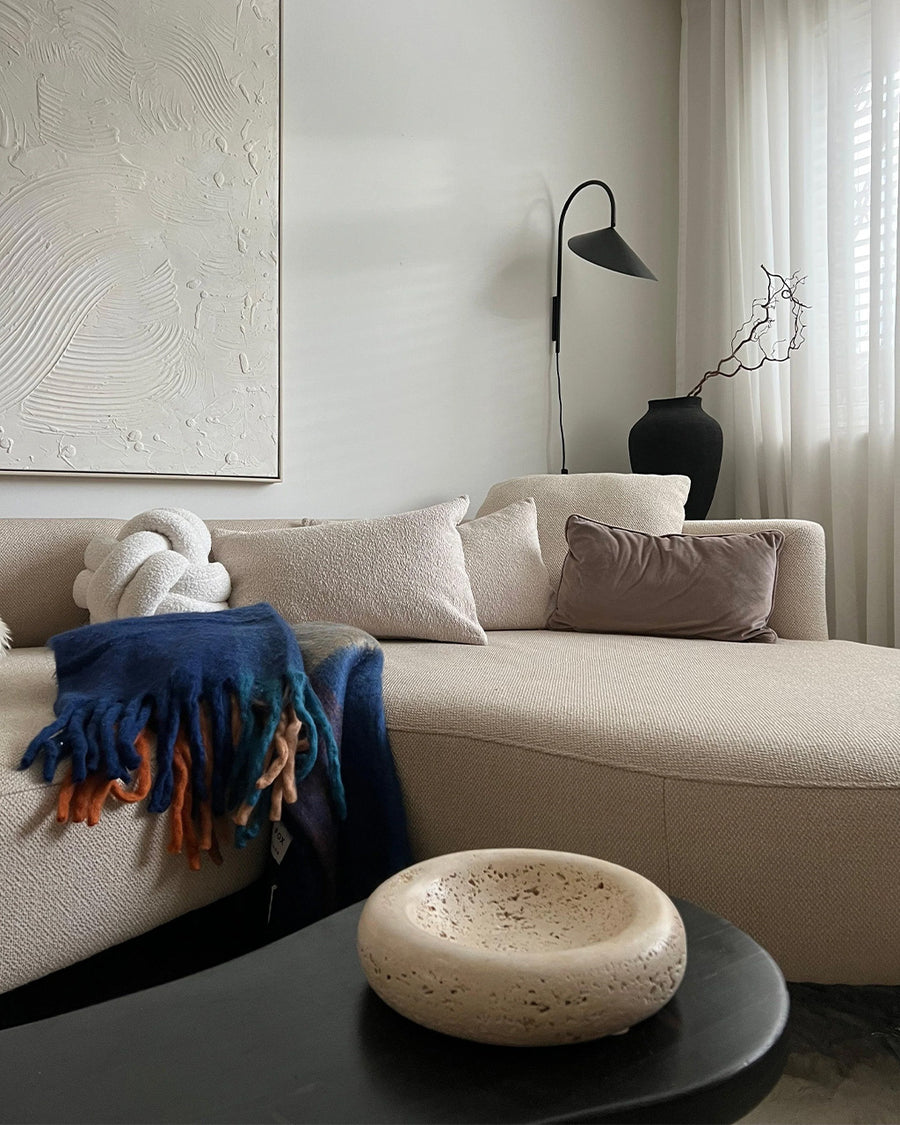 navy, light blue, orange and yellow checkered throw blanket with fringe on a couch