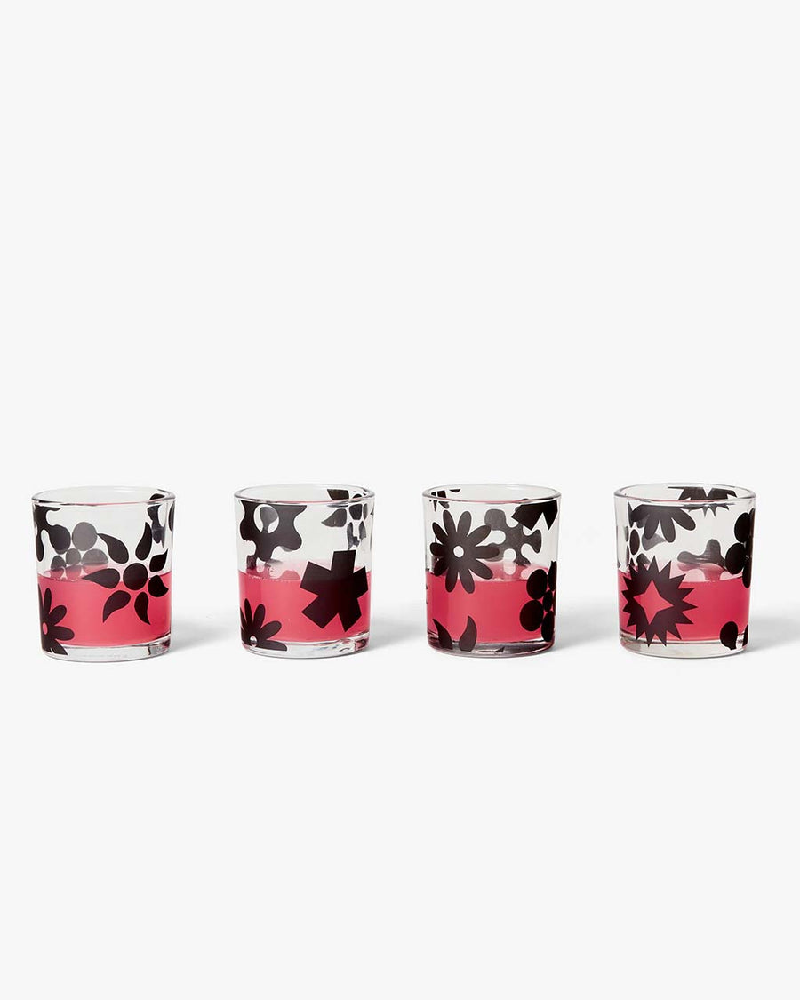 set of four glasses with black abstract print with liquid inside