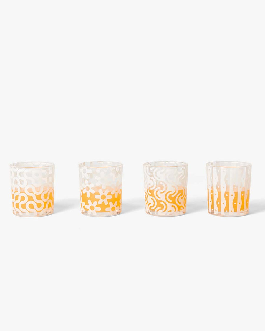 set of four glasses with abstract print with liquids inside