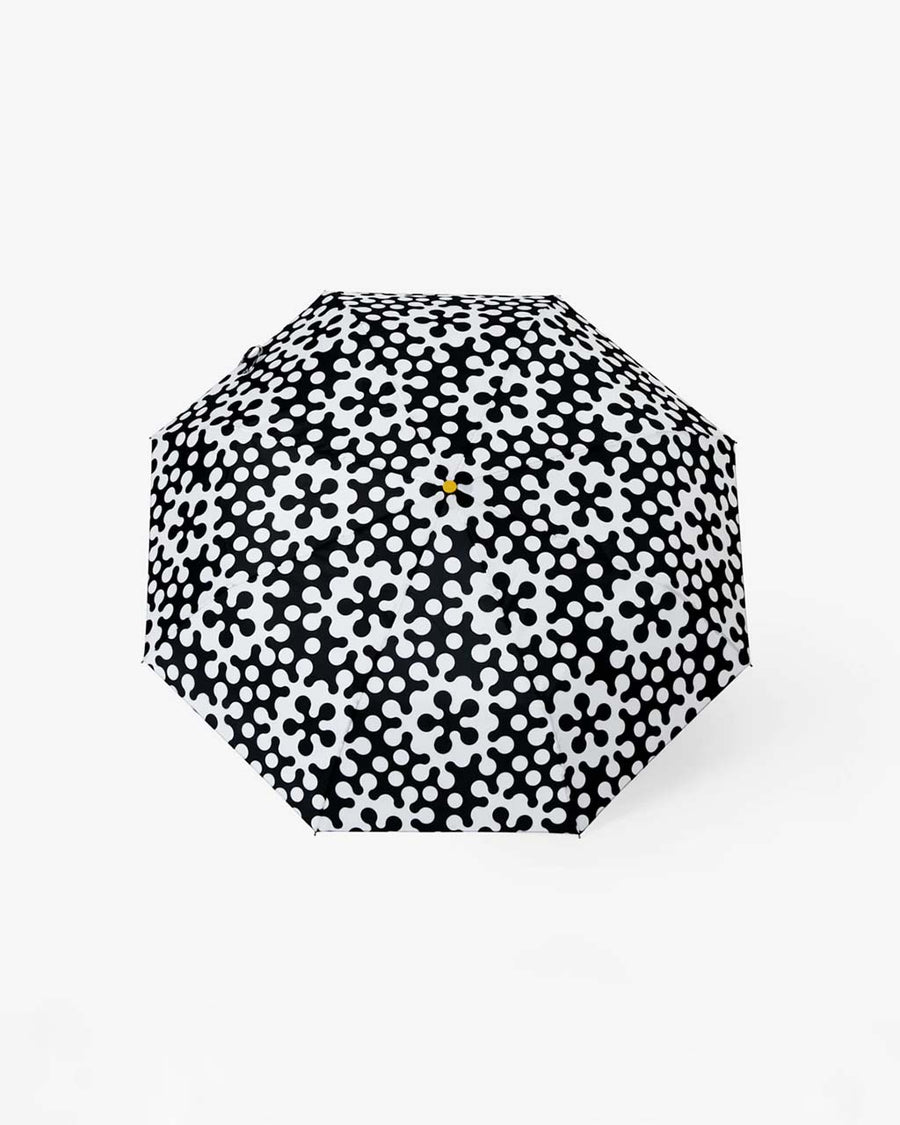 top view of opened black and white abstract print umbrella