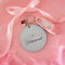 light blue leatherette mirror keychain with cursive 'delusional' across the front and with heart and ballet slipper charm