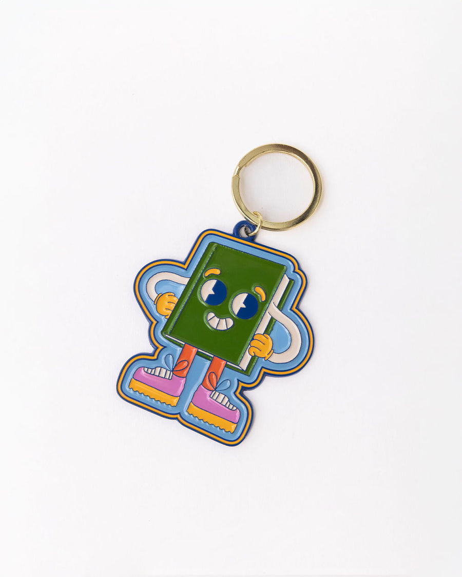 side view of enamel keychain with green book man with arms, face and legs