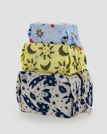 set of 3 zip set bags: light blue ditsy charms, yellow sun and moons, and cream and navy cherubs