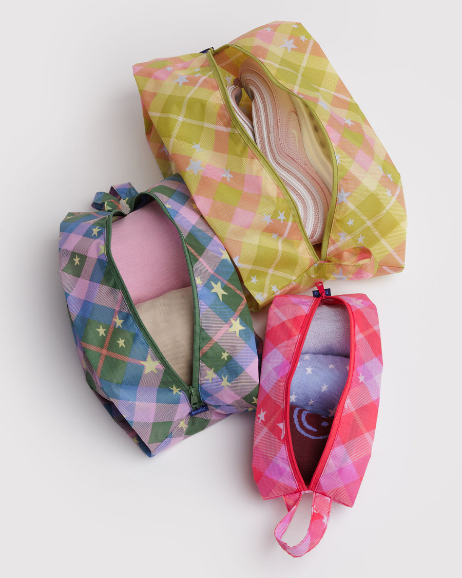 set of 3 3d zip pouches: pink plaid star, green/blue plaid star, and yellow plaid star with items inside