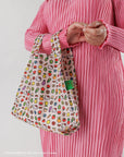 model wearing beige baby baggu with all over hello kitty and fruit and veggie prints