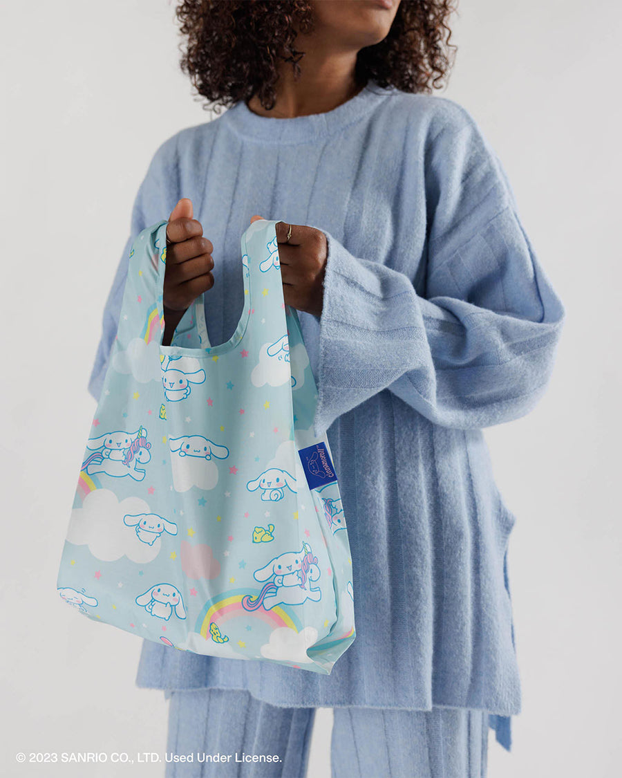 model wearing light blue baby baggu with all over rainbow and cinnamoroll print
