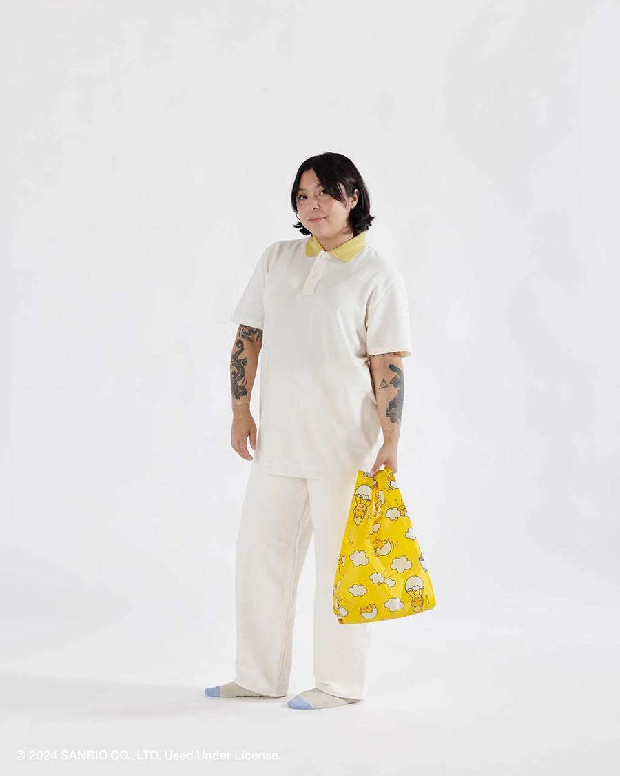 model holding yellow gudetama baby baggu