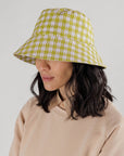 model wearing pink and pistachio pixel gingham print bucket hat