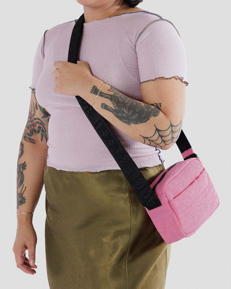 model wearing bright pink baggu camera bag