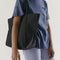 model wearing black cloud bag