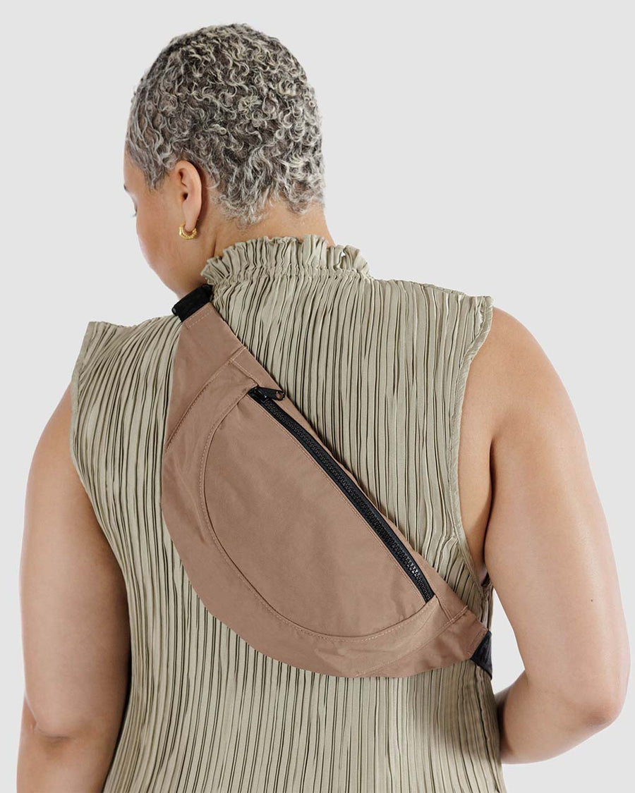 model wearing light brown crescent fanny pack
