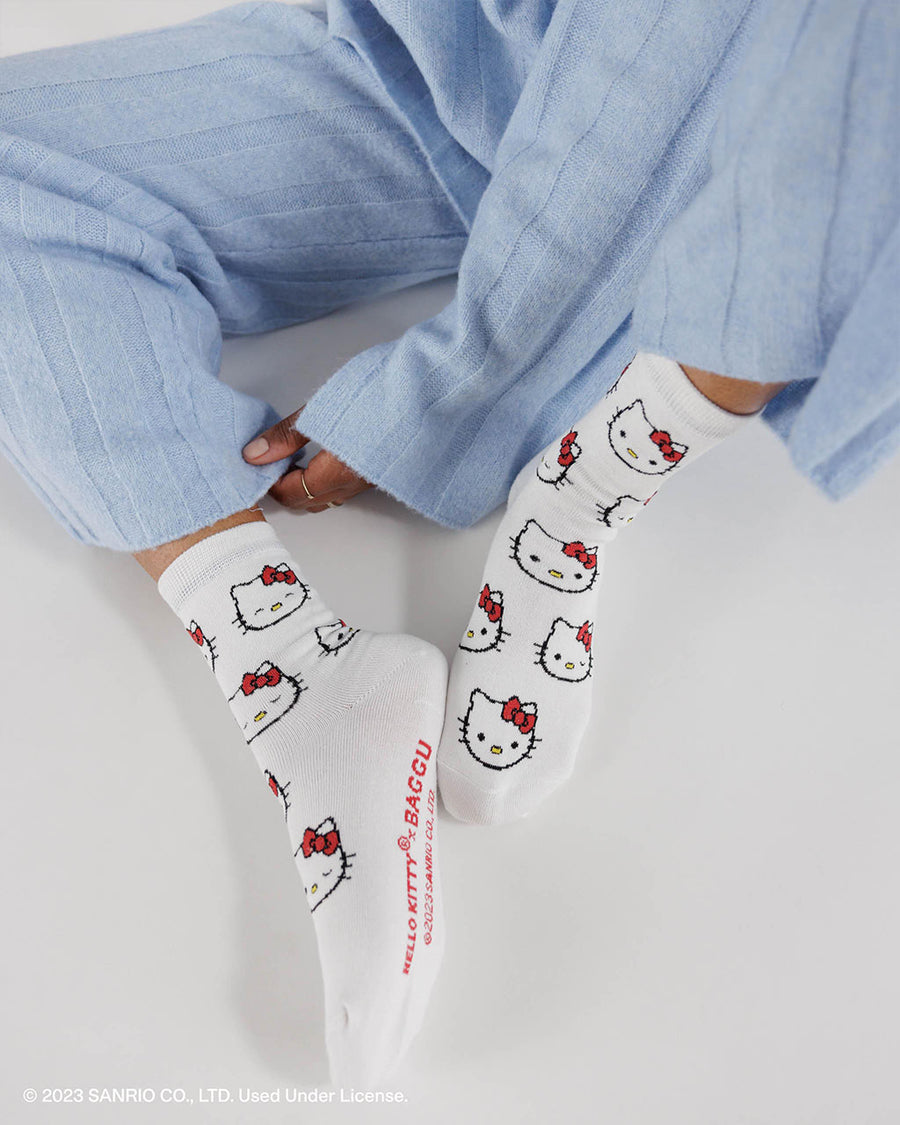 model showing underside of white socks with all over hello kitty face print