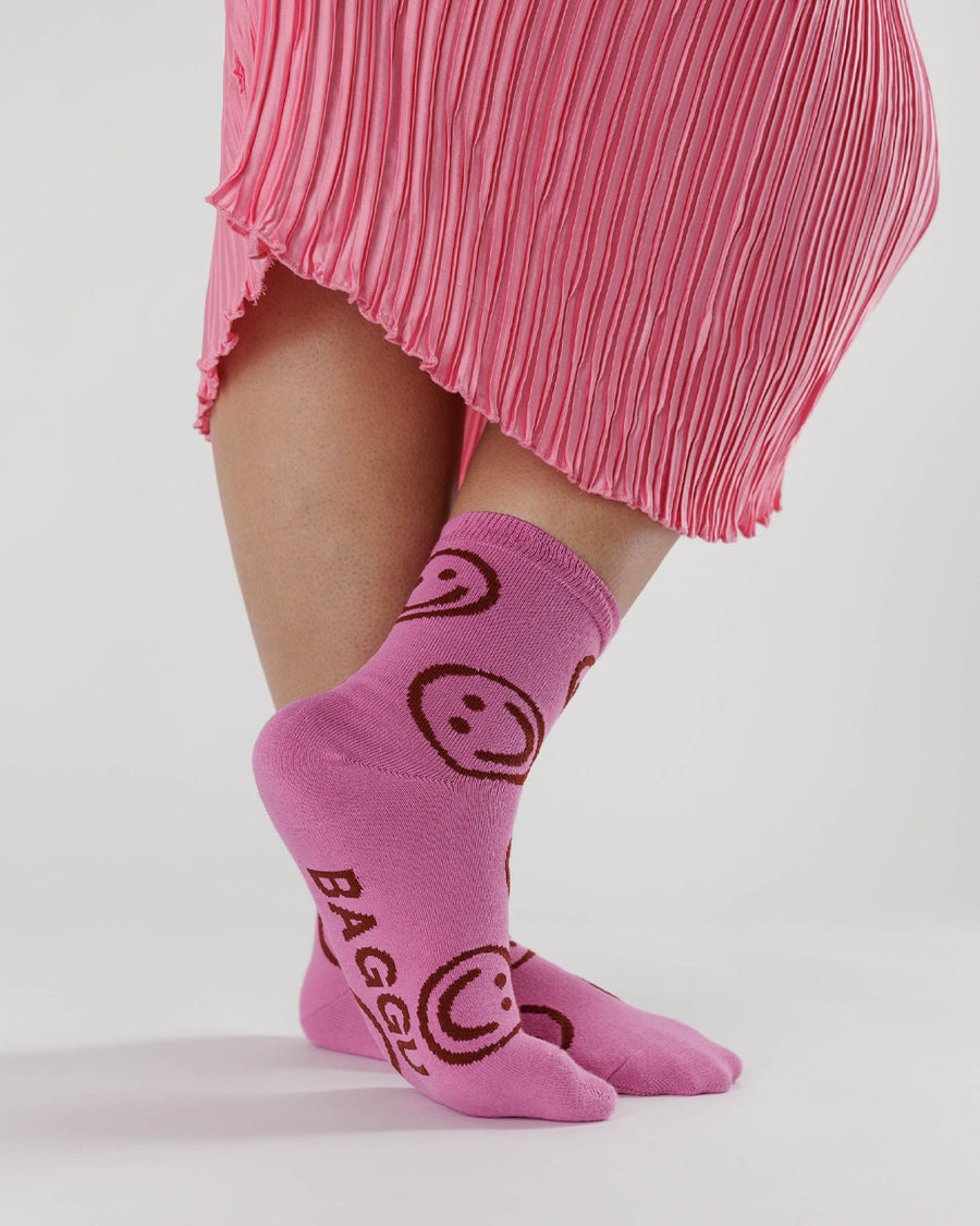 model wearing hot pink socks with pink smiley faces