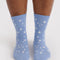 model wearing light blue crew socks with white star print
