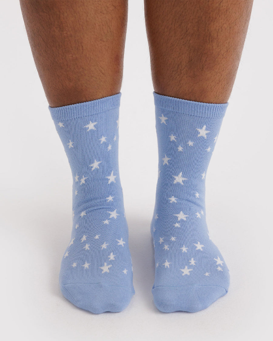 model wearing light blue crew socks with white star print