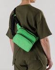 model wearing light green nylon fanny pack