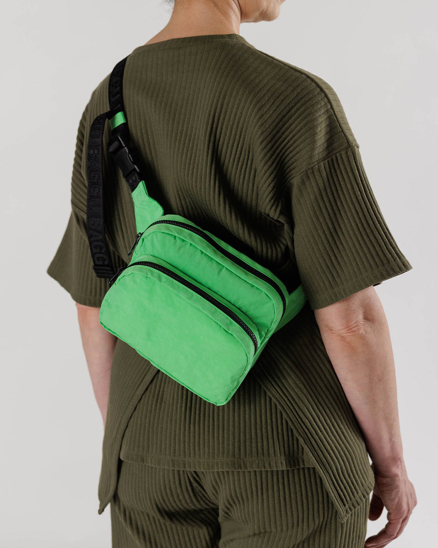 model wearing light green nylon fanny pack