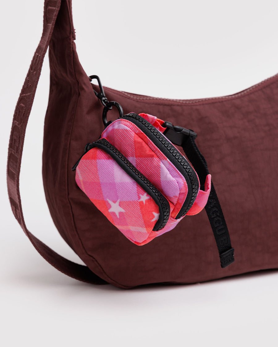 pink plaid star fanny pack charm with black zipper and strap hanging on a burgundy bag