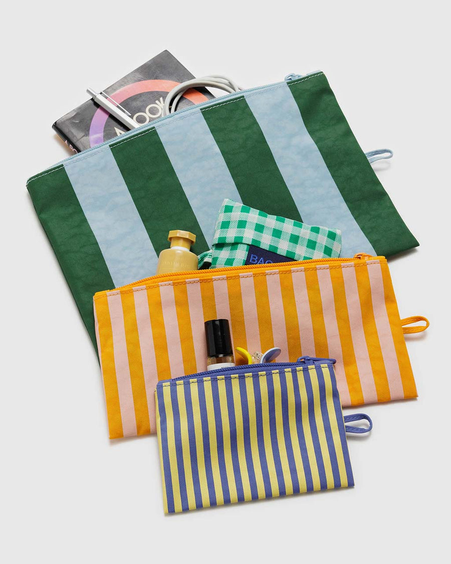 set of three stripe pouches: small blue/yellow thin stripe, medium orange/pink stripe and large blue/green large stripe filled with items