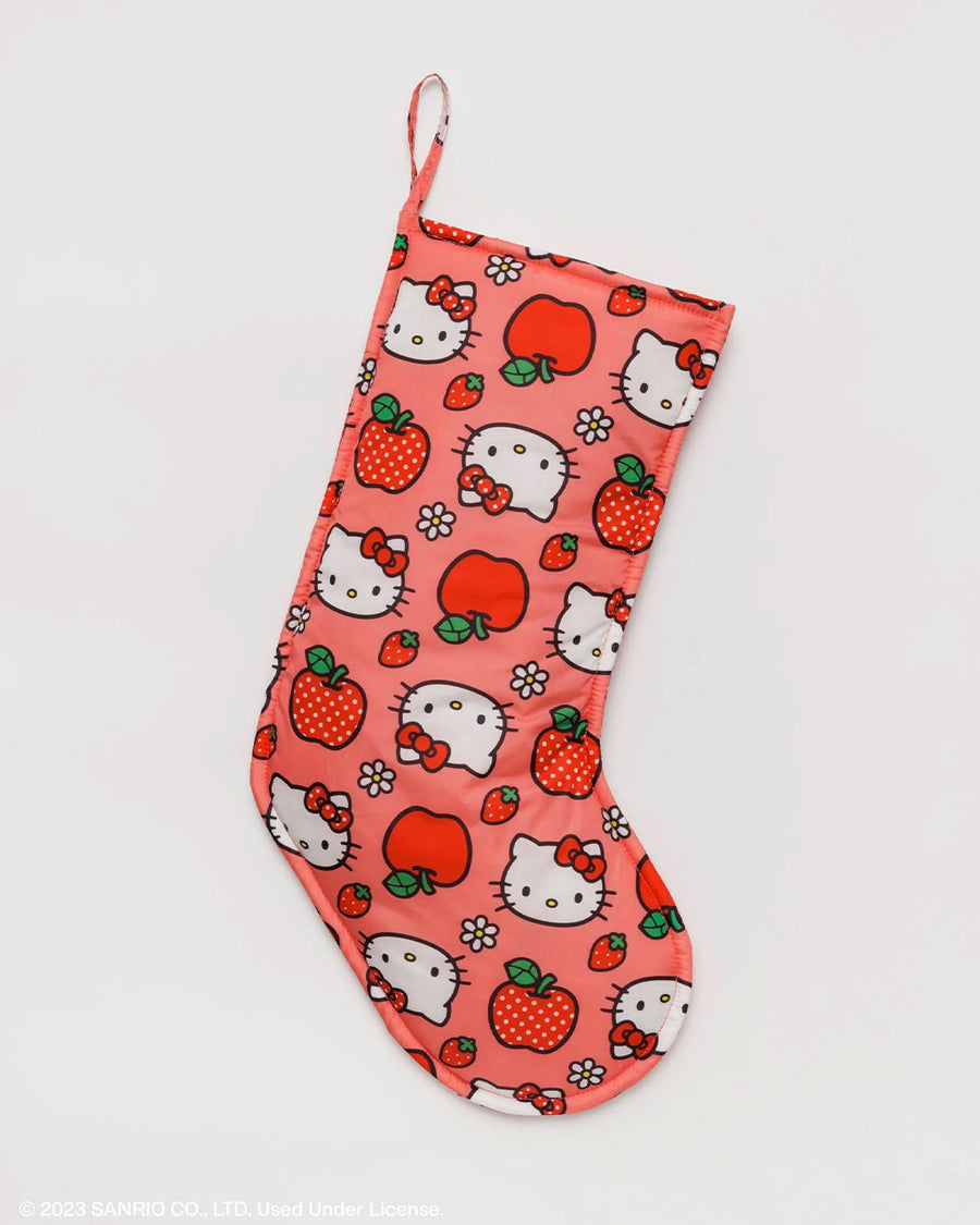 pink holiday stocking with hello kitty faces and apple print