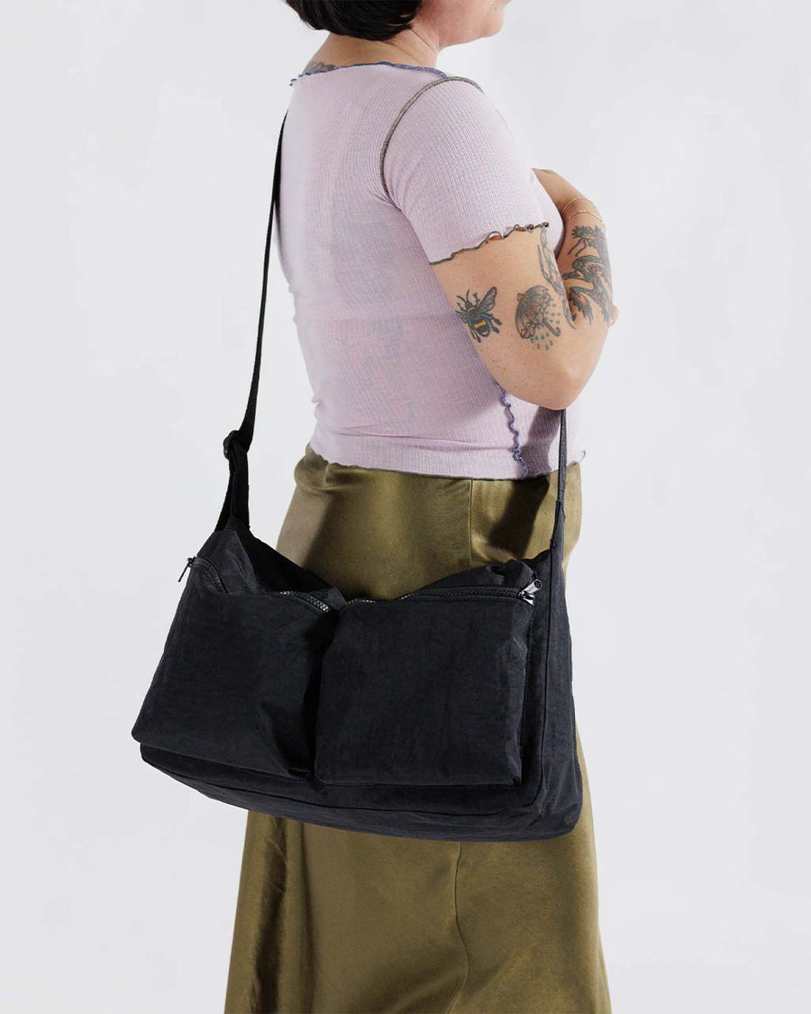 model wearing black large cargo crossbody bag