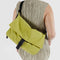 model wearing lemongrass nylon messenger bag with black front buckle