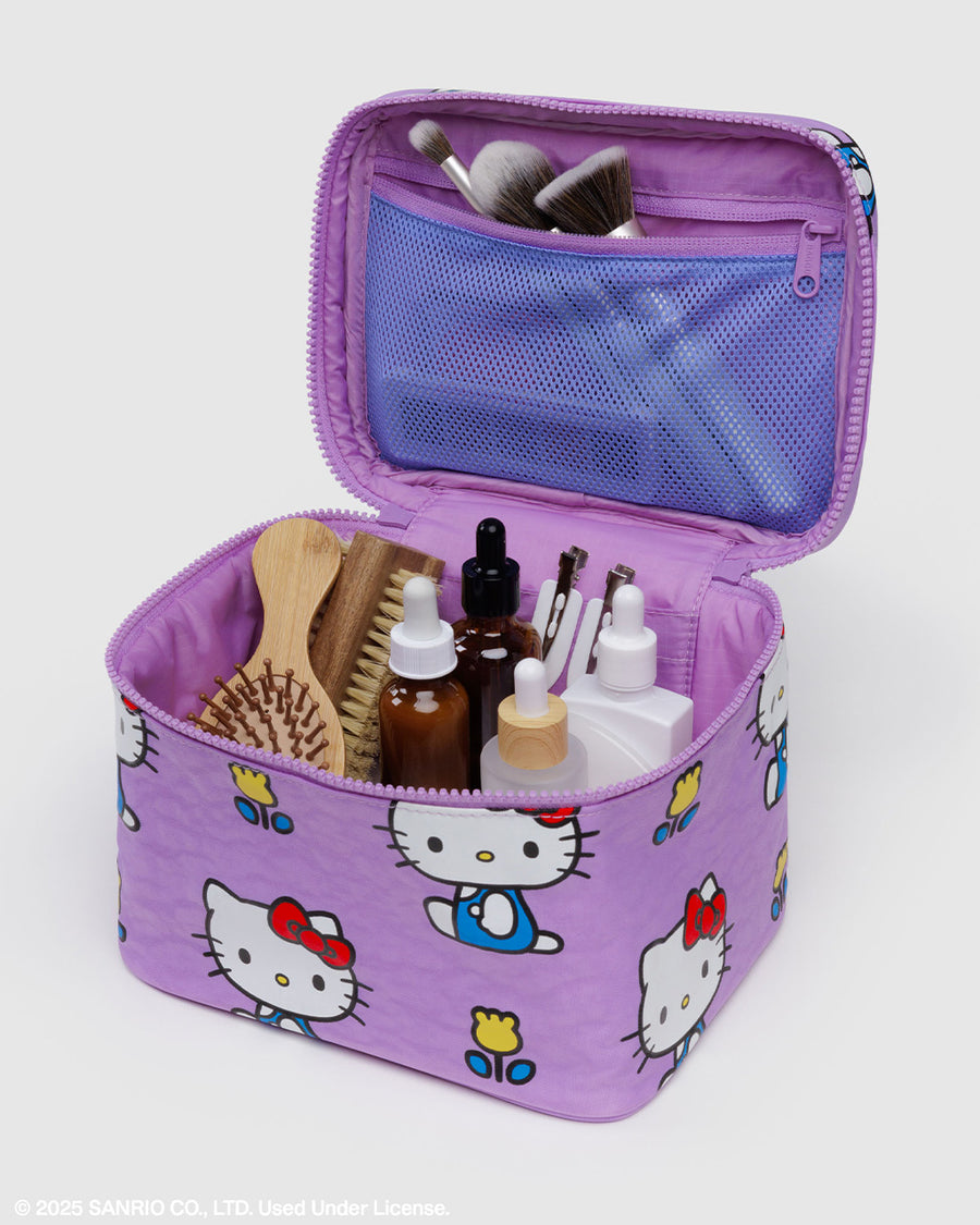 purple large cosmetic bag with hello kitty and yellow tulips print with self care items inside