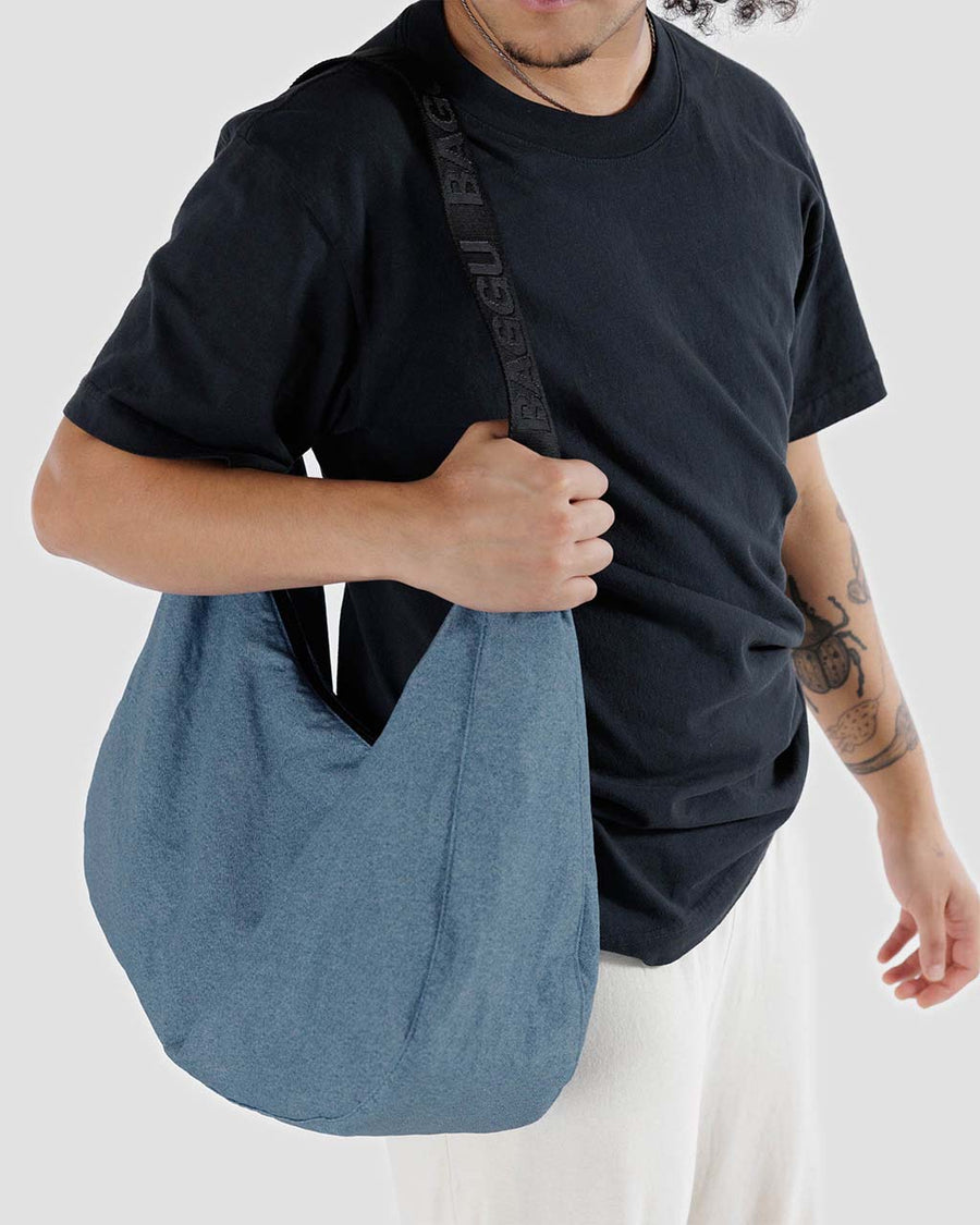 model carrying digital denim blue large crescent bag