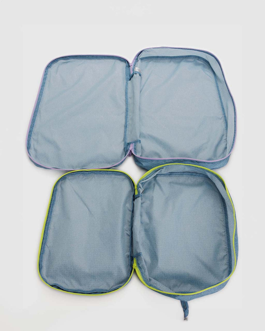 interior of set of two large packing cubes in digital denim print with neon zippers