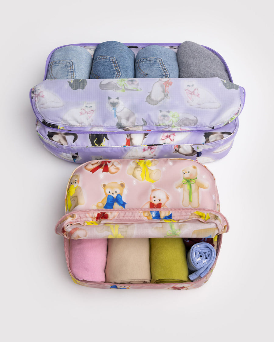 set of 2 large packing cubes: small pink fancy teddy bears, and lilac large fancy cats with clothing inside