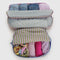 two large packing cube sets with various colorful stripe patterns and blue and lavender zippers filled with clothing