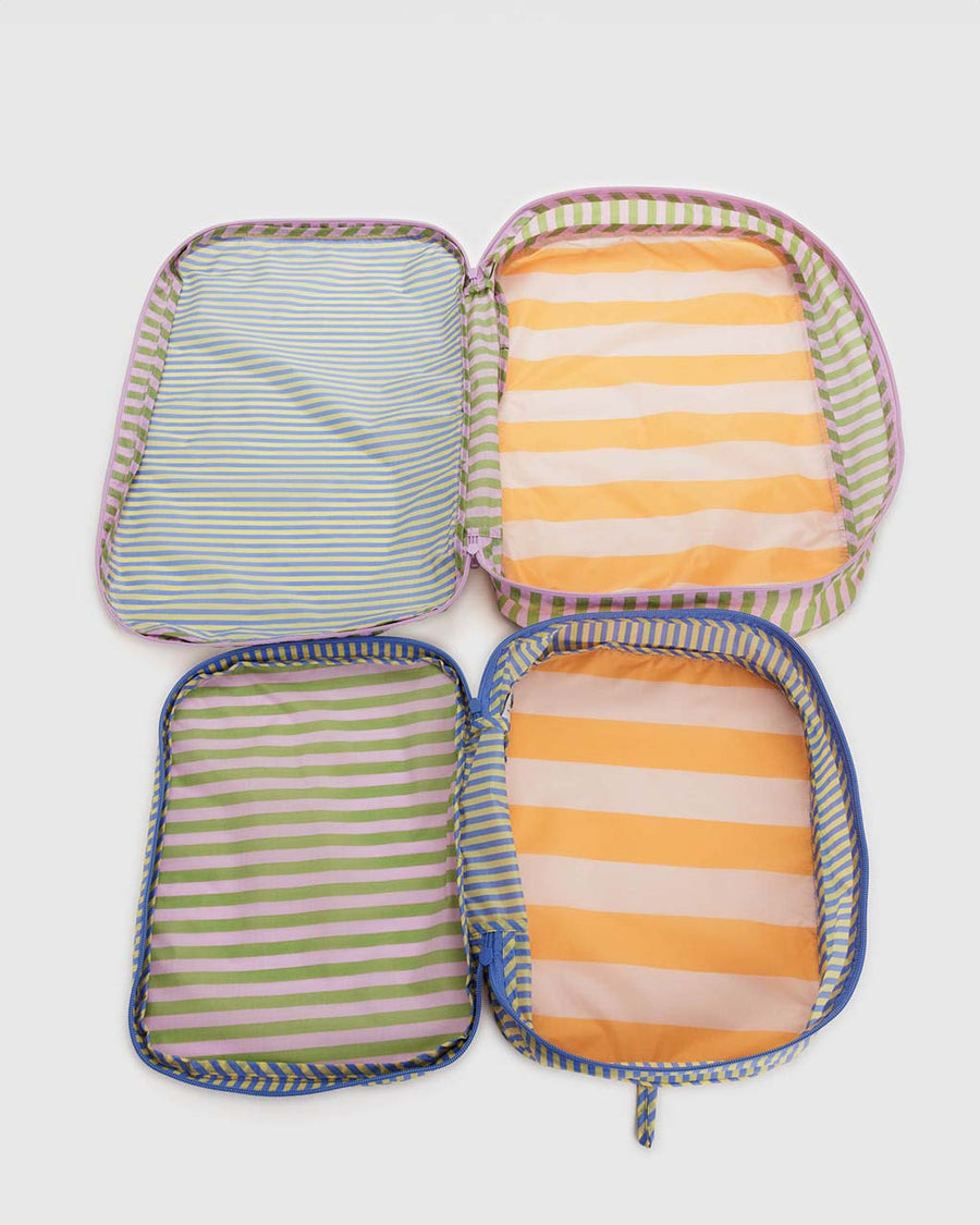 interior of two large packing cube sets with various colorful stripe patterns and blue and lavender zippers