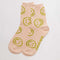 light pink crew socks with yellow/green smiley face print