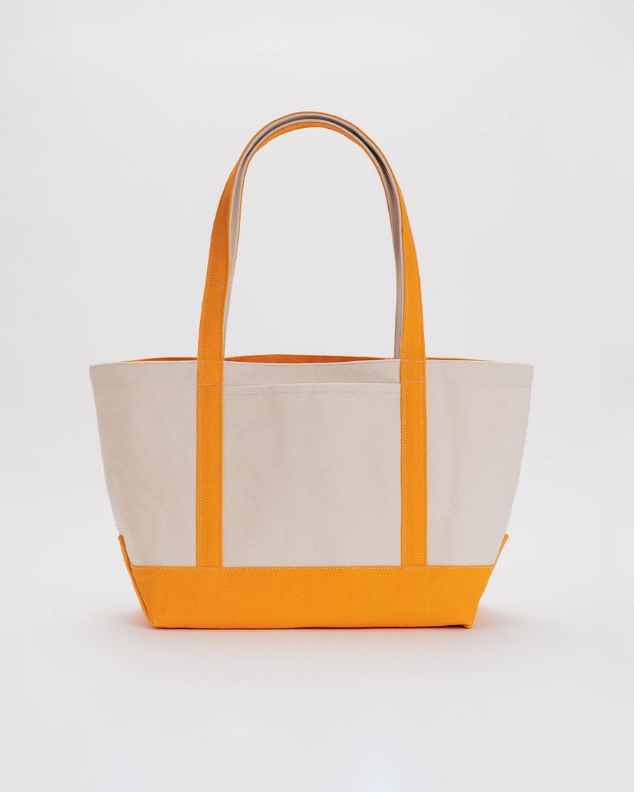 medium boat tote with tan canvas body and tangerine straps and trim